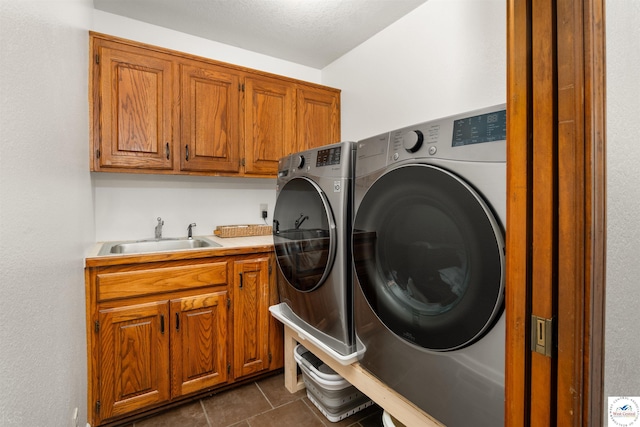 2105 Stonewood Cir, Sedalia, MO 65301 - washroom with cabinet space, independent washer and dryer, and dark tile patterned floors