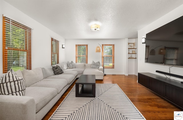 2105 Stonewood Cir, Sedalia, MO 65301 - living area featuring wood finished floors and a textured ceiling
