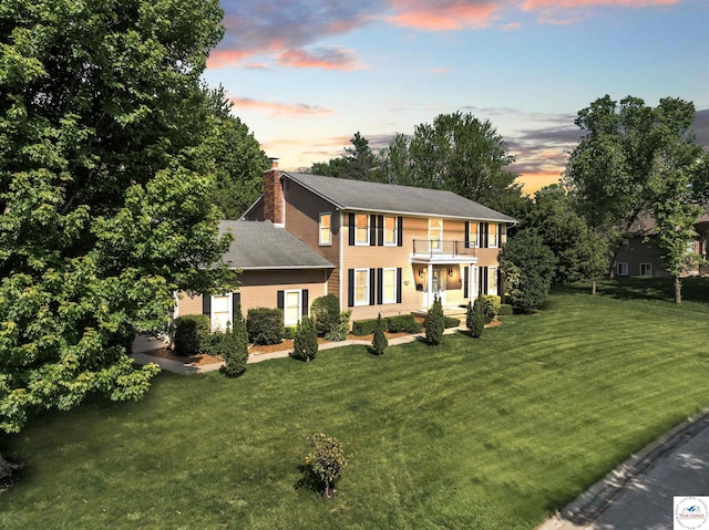 2105 Stonewood Cir, Sedalia, MO 65301 - colonial home with a balcony, a yard, and a chimney