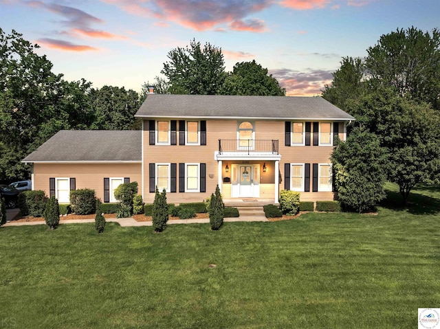 2105 Stonewood Cir, Sedalia, MO 65301 - view of front of house with a balcony, a chimney, and a lawn