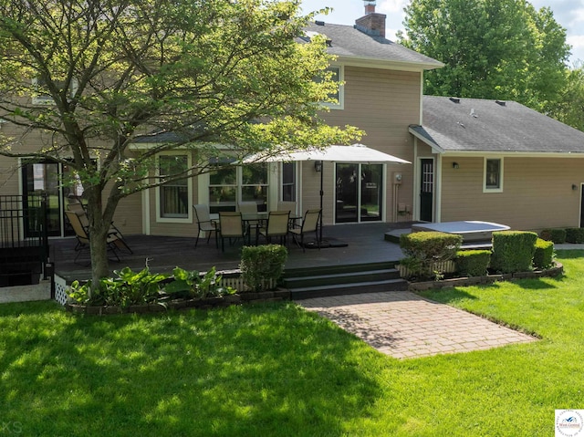 2105 Stonewood Cir, Sedalia, MO 65301 - back of house featuring a chimney, a wooden deck, roof with shingles, a lawn, and outdoor dining area