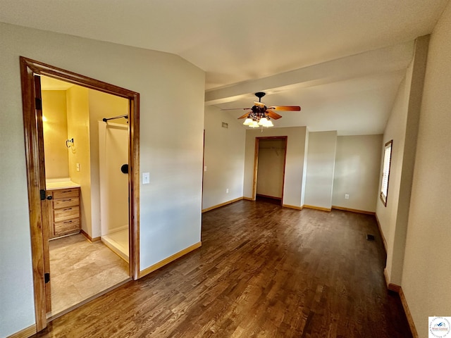 616 E Main St, Warsaw, MO 65355 - spare room featuring dark wood-style flooring, ceiling fan, and vaulted ceiling