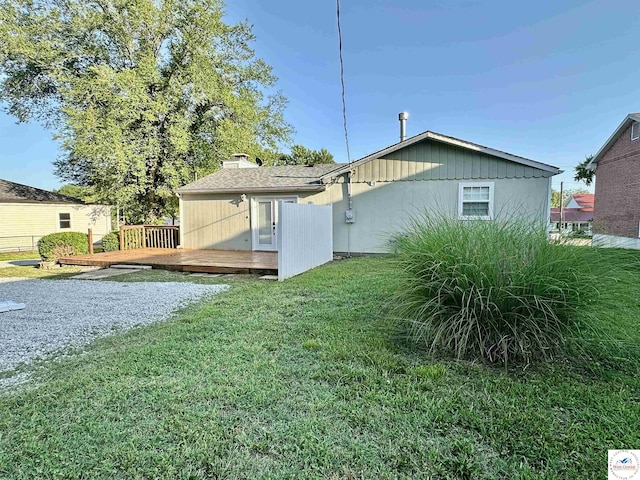 616 E Main St, Warsaw, MO 65355 - rear view of house featuring a wooden deck, a yard, and a chimney