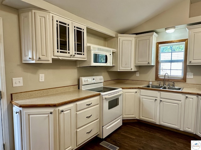 616 E Main St, Warsaw, MO 65355 - kitchen featuring white appliances, vaulted ceiling, dark wood-style flooring, light countertops, and white cabinets