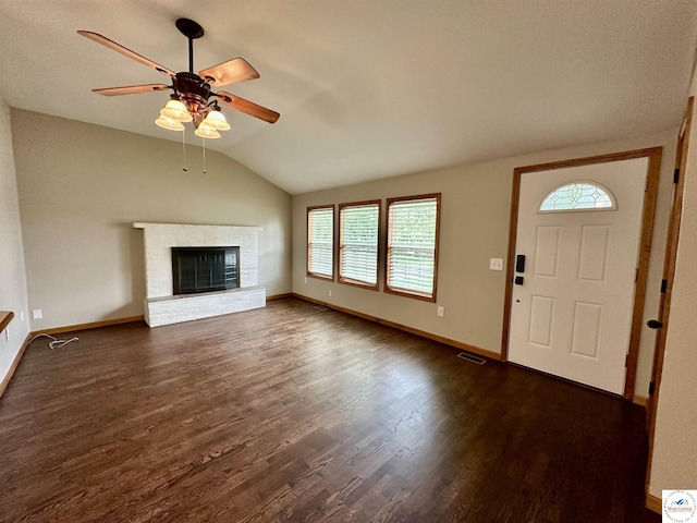 616 E Main St, Warsaw, MO 65355 - unfurnished living room with a ceiling fan, healthy amount of natural light, lofted ceiling, dark wood-type flooring, and a brick fireplace