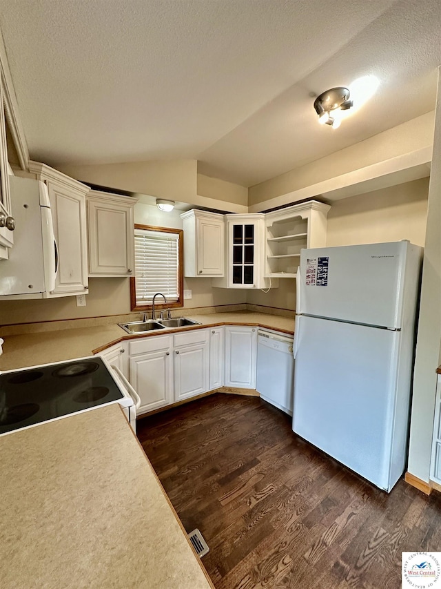 616 E Main St, Warsaw, MO 65355 - kitchen featuring white appliances, dark wood-type flooring, vaulted ceiling, white cabinetry, and glass insert cabinets