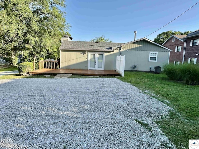 616 E Main St, Warsaw, MO 65355 - rear view of house with french doors, a deck, a chimney, and a lawn