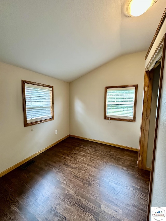 616 E Main St, Warsaw, MO 65355 - unfurnished bedroom with lofted ceiling, multiple windows, and wood finished floors