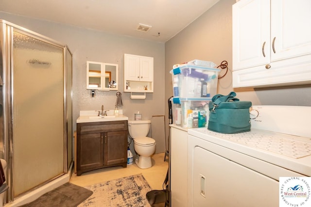 24401 Black Hawk Trl, Cole Camp, MO 65325 - bathroom with washer / clothes dryer, a stall shower, toilet, and vanity