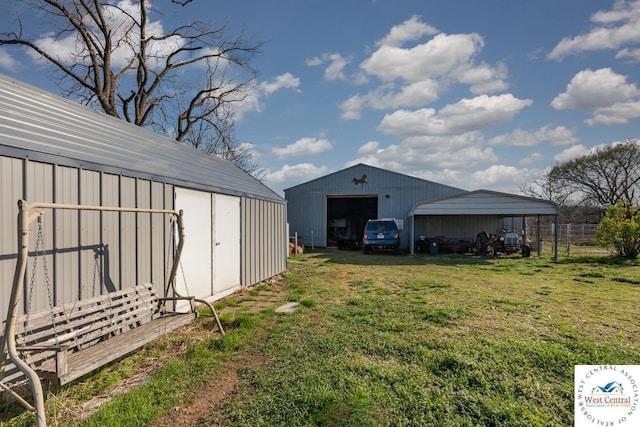 24401 Black Hawk Trl, Cole Camp, MO 65325 - view of green lawn with a garage, an outdoor structure, and an outbuilding