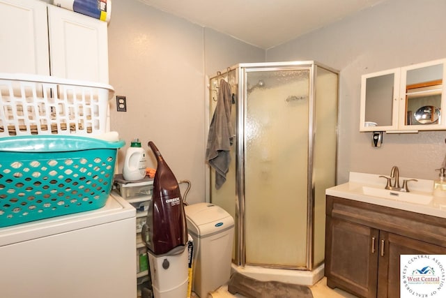 24401 Black Hawk Trl, Cole Camp, MO 65325 - bathroom with a shower stall, vanity, and washer / clothes dryer