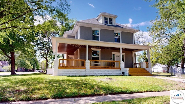 401 N Prospect St, Sedalia, MO 65301 - traditional style home featuring covered porch, brick siding, and a front lawn