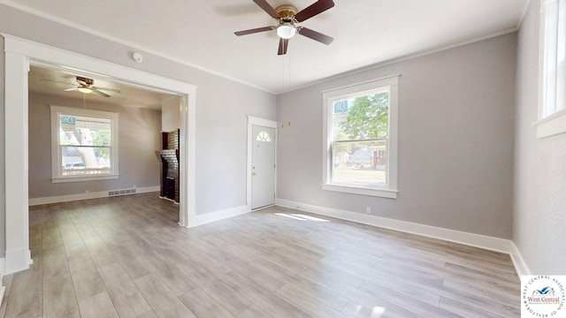 401 N Prospect St, Sedalia, MO 65301 - spare room featuring a ceiling fan, light wood-style floors, crown molding, baseboards, and a smoke detector