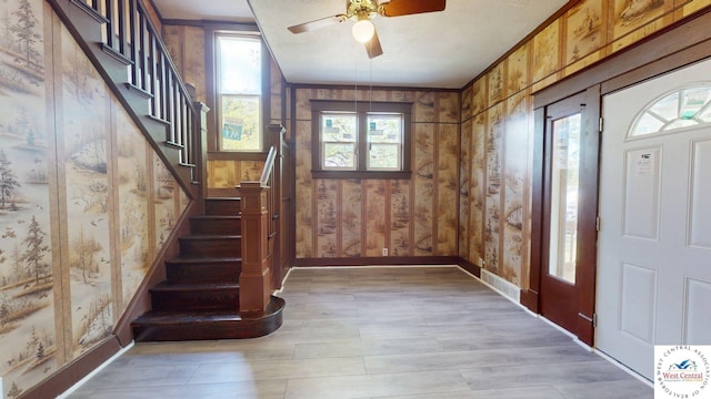 401 N Prospect St, Sedalia, MO 65301 - entrance foyer with plenty of natural light, stairs, baseboards, and wooden walls