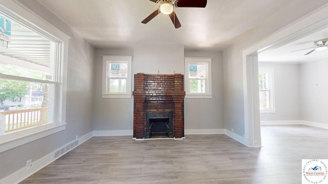 401 N Prospect St, Sedalia, MO 65301 - unfurnished living room featuring ceiling fan, plenty of natural light, a fireplace, and baseboards