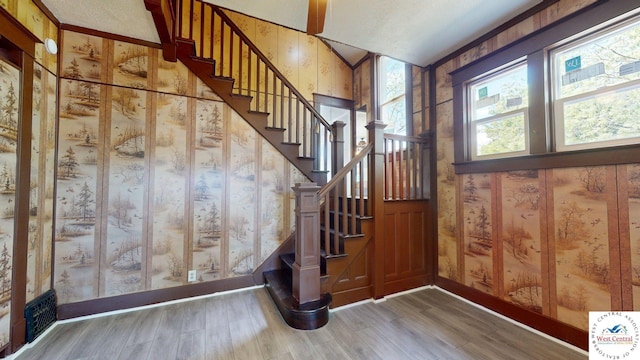 401 N Prospect St, Sedalia, MO 65301 - stairway featuring wood finished floors, wallpapered walls, and baseboards