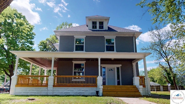 401 N Prospect St, Sedalia, MO 65301 - view of front of property featuring a porch, brick siding, and fence
