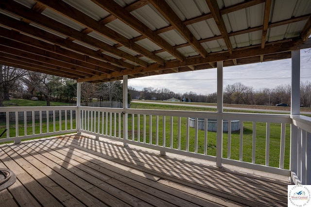 wooden deck featuring a lawn