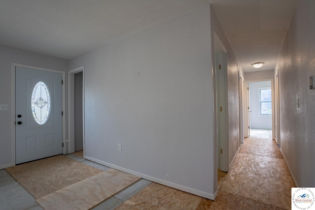 foyer entrance featuring baseboards