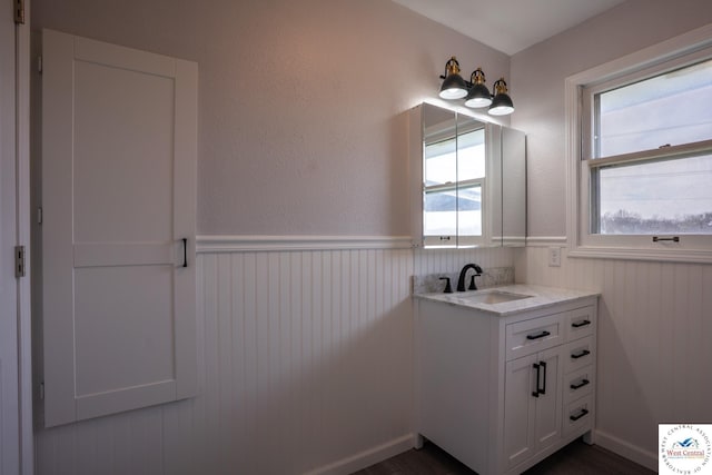 bathroom featuring vanity and a wainscoted wall