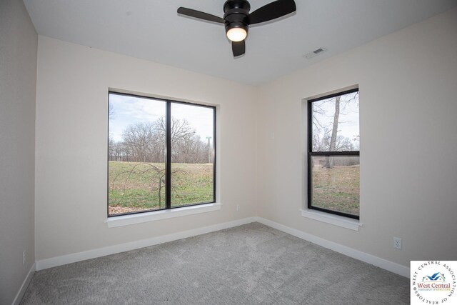 26112 Georgetown Ave, Warsaw, MO 65355 - carpeted spare room featuring baseboards, visible vents, a ceiling fan, and plenty of natural light