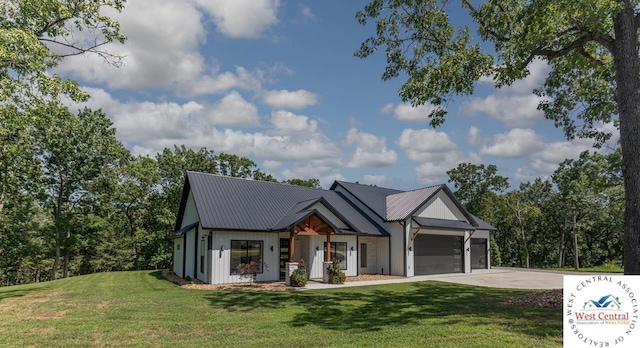 26112 Georgetown Ave, Warsaw, MO 65355 - modern inspired farmhouse with metal roof, a front yard, an attached garage, and concrete driveway