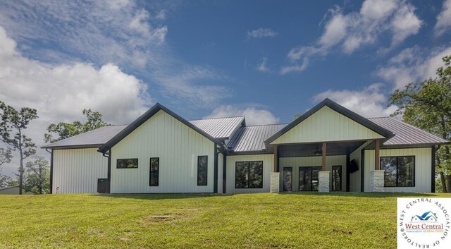 26112 Georgetown Ave, Warsaw, MO 65355 - back of house featuring a standing seam roof, metal roof, and a yard