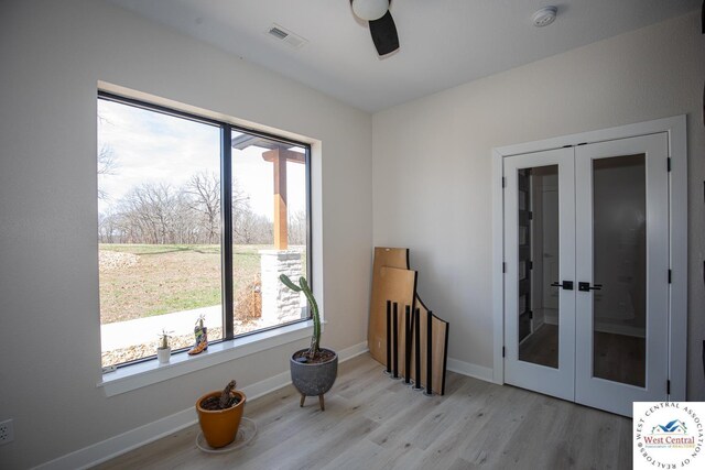 26112 Georgetown Ave, Warsaw, MO 65355 - interior space with visible vents, a wealth of natural light, french doors, and light wood-type flooring