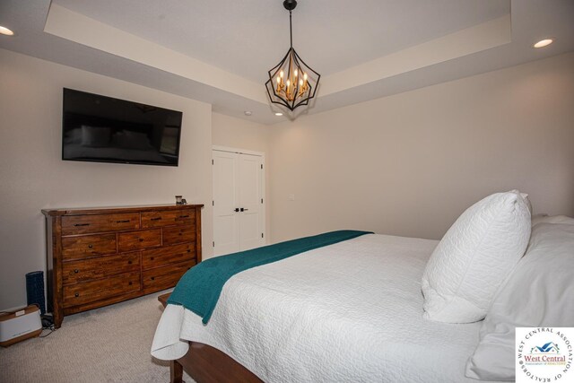 26112 Georgetown Ave, Warsaw, MO 65355 - bedroom featuring light colored carpet, a raised ceiling, recessed lighting, and a notable chandelier