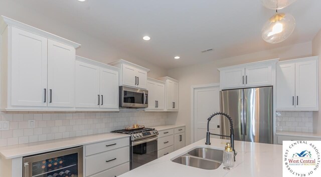 26112 Georgetown Ave, Warsaw, MO 65355 - kitchen featuring recessed lighting, a sink, tasteful backsplash, appliances with stainless steel finishes, and beverage cooler