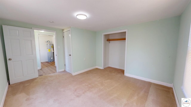 400 E 12th St, Sedalia, MO 65301 - unfurnished bedroom featuring carpet flooring, baseboards, and water heater