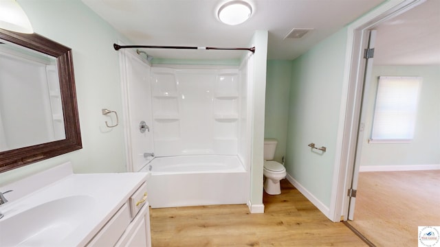 400 E 12th St, Sedalia, MO 65301 - full bathroom featuring toilet, vanity, wood finished floors, and tub / shower combination