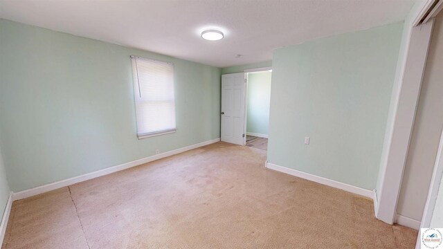 400 E 12th St, Sedalia, MO 65301 - unfurnished bedroom featuring light carpet, baseboards, and a closet