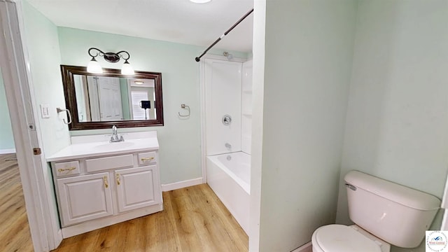 400 E 12th St, Sedalia, MO 65301 - full bathroom with vanity, wood finished floors, toilet, bathtub / shower combination, and baseboards