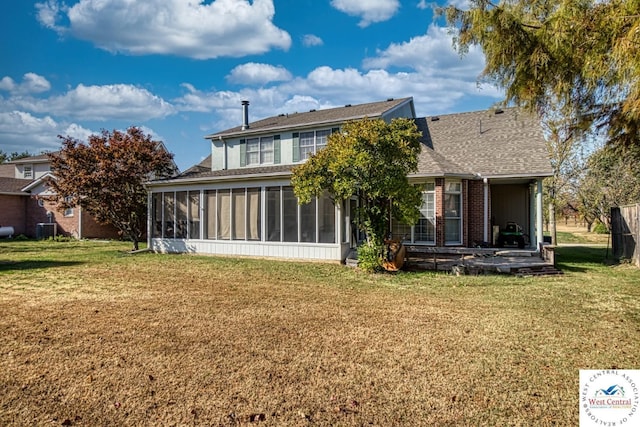 back of property featuring cooling unit, a sunroom, a yard, and roof with shingles