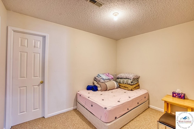 bedroom with light colored carpet, visible vents, a textured ceiling, and baseboards