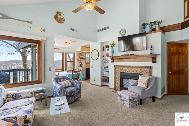 1436 Cherokee Rd, Lake Ozark, MO 65049 - carpeted living room featuring a high ceiling, visible vents, ceiling fan, and a fireplace