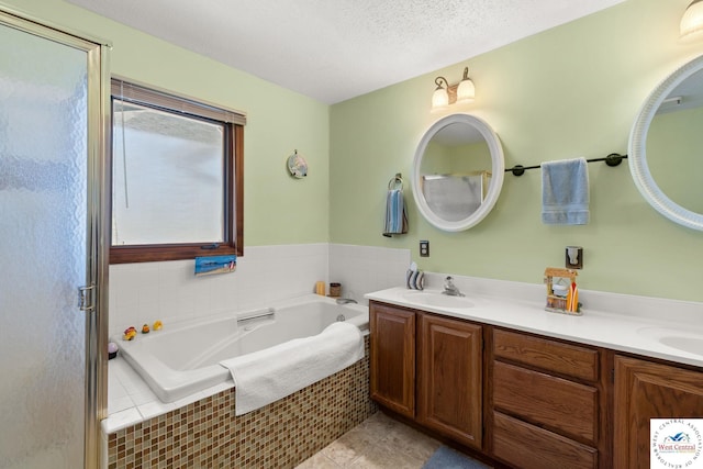 1436 Cherokee Rd, Lake Ozark, MO 65049 - full bath with a sink, tile patterned floors, double vanity, a garden tub, and a textured ceiling