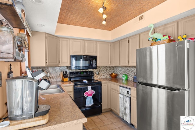 1436 Cherokee Rd, Lake Ozark, MO 65049 - kitchen featuring light tile patterned floors, visible vents, light countertops, black appliances, and backsplash