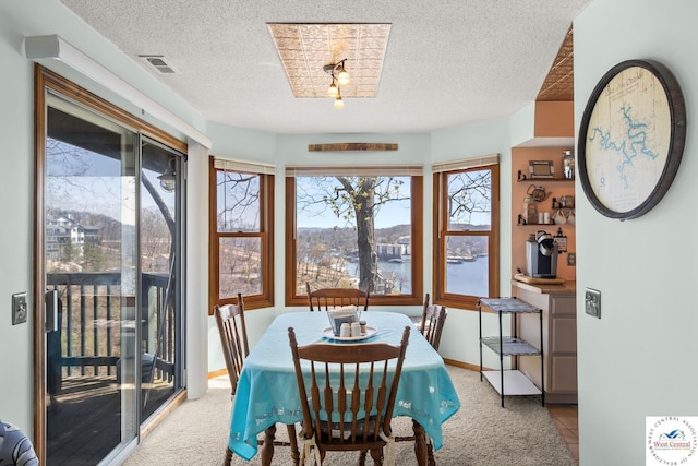 1436 Cherokee Rd, Lake Ozark, MO 65049 - carpeted dining room featuring a textured ceiling, visible vents, and baseboards