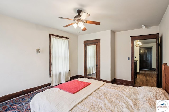 309 E Gay St, Warrensburg, MO 64093 - bedroom featuring a ceiling fan, wood finished floors, and a chandelier