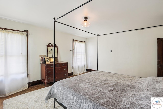 309 E Gay St, Warrensburg, MO 64093 - bedroom featuring wood finished floors and baseboards