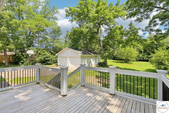 309 E Gay St, Warrensburg, MO 64093 - deck with an outdoor structure, a detached garage, a yard, and view of wooded area
