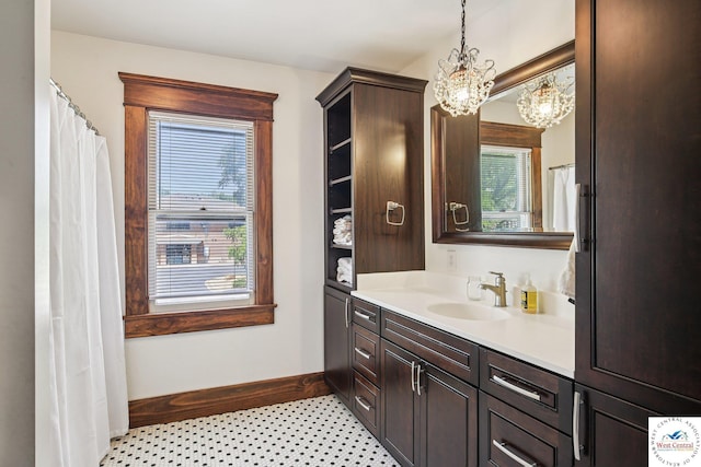 309 E Gay St, Warrensburg, MO 64093 - full bath featuring a chandelier, vanity, and plenty of natural light