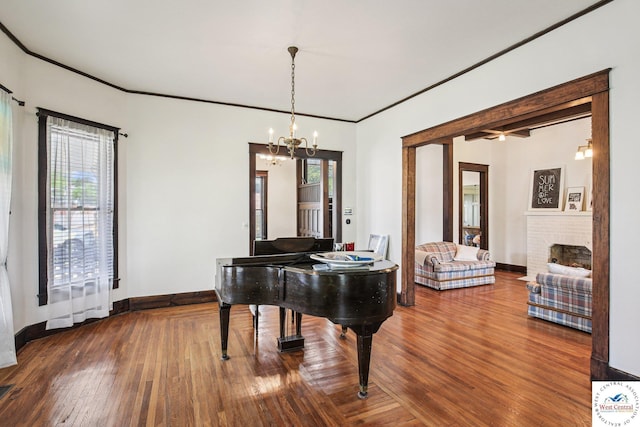 309 E Gay St, Warrensburg, MO 64093 - dining area with a chandelier, wood finished floors, a brick fireplace, and crown molding