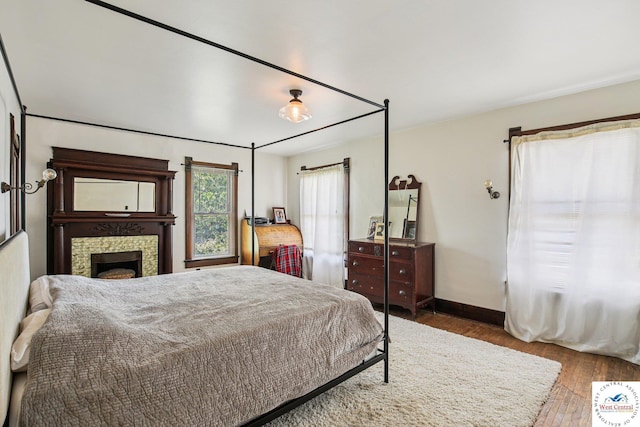 309 E Gay St, Warrensburg, MO 64093 - bedroom featuring wood finished floors and a fireplace