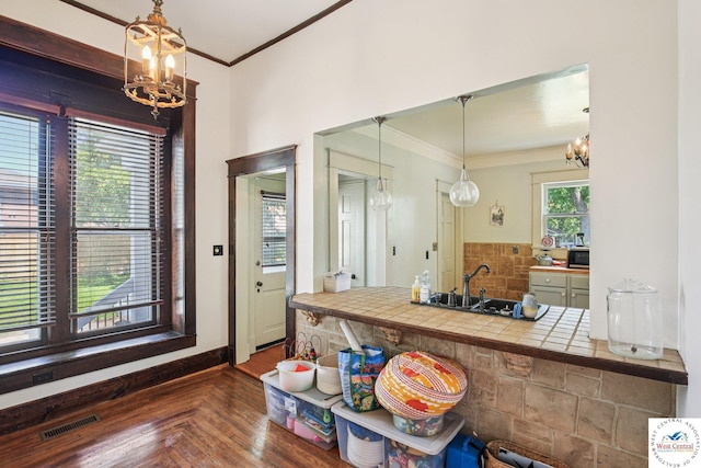309 E Gay St, Warrensburg, MO 64093 - kitchen with a chandelier, ornamental molding, backsplash, and pendant lighting