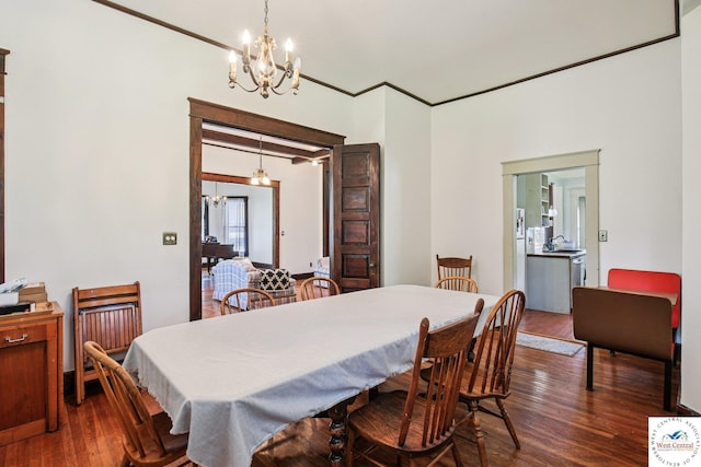 309 E Gay St, Warrensburg, MO 64093 - dining area featuring a chandelier and dark wood-style floors
