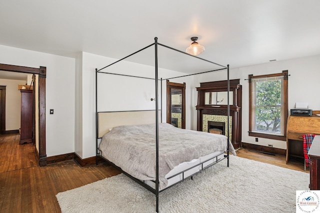 309 E Gay St, Warrensburg, MO 64093 - bedroom with hardwood / wood-style floors and a fireplace