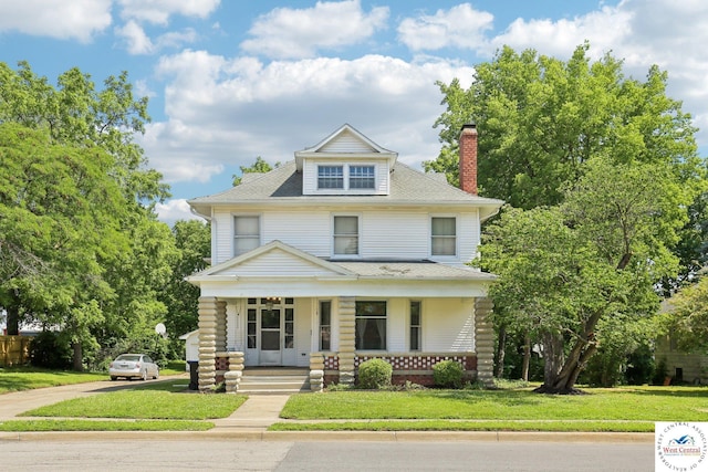 309 E Gay St, Warrensburg, MO 64093 - traditional style home with a porch, a chimney, a front yard, concrete driveway, and roof with shingles